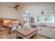 Bright, open kitchen featuring white cabinets, stainless steel appliances and a central wood island with a dining area at 7826 W Kerry Ln, Glendale, AZ 85308