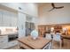 Spacious kitchen featuring white cabinets, granite countertops, stainless steel appliances, and an open dining area at 7826 W Kerry Ln, Glendale, AZ 85308