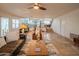 Living room featuring tile floors, comfortable seating, and an open view of the kitchen and dining area at 7826 W Kerry Ln, Glendale, AZ 85308