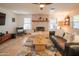 Spacious living room showcasing tile floors, stone fireplace, ceiling fan, and a comfortable seating area at 7826 W Kerry Ln, Glendale, AZ 85308