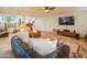 Bright and airy living room featuring tile floors, leather furniture, ceiling fan, and updated entertainment center at 7826 W Kerry Ln, Glendale, AZ 85308