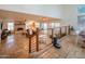 Open-concept living room with tile flooring, a cozy fireplace, and a view of the dining area at 7826 W Kerry Ln, Glendale, AZ 85308