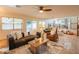 Spacious living room featuring comfortable seating, tile floors, large windows and views into the backyard at 7826 W Kerry Ln, Glendale, AZ 85308