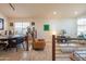 Bright living room featuring stone floors, a dining area, and a cozy seating area at 7826 W Kerry Ln, Glendale, AZ 85308