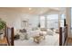 Bright living room featuring a white sofa set, wood coffee table, and large windows with beautiful outdoor views at 7826 W Kerry Ln, Glendale, AZ 85308