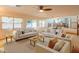 Expansive living area with multiple seating arrangements, large windows, and an open layout perfect for entertaining at 7826 W Kerry Ln, Glendale, AZ 85308