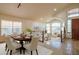 Spacious living area with a combination of dining and living spaces, featuring large windows and elegant decor at 7826 W Kerry Ln, Glendale, AZ 85308
