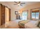 Airy main bedroom with en suite bathroom access, ceiling fan, and plenty of natural light at 7826 W Kerry Ln, Glendale, AZ 85308