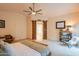 Open main bedroom showcases sliding barn doors to the bathroom, ceiling fan, and sunny ambiance at 7826 W Kerry Ln, Glendale, AZ 85308