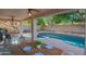 Covered patio dining area overlooking the pool, perfect for outdoor meals and relaxation at 7826 W Kerry Ln, Glendale, AZ 85308