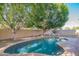 The backyard pool is surrounded by lush trees, creating a private and serene oasis at 7826 W Kerry Ln, Glendale, AZ 85308