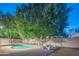 Large backyard featuring a refreshing pool, mature trees, and comfortable outdoor seating at 7826 W Kerry Ln, Glendale, AZ 85308