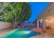 Inviting backyard pool with mature trees and ample patio space, perfect for outdoor entertaining at 7826 W Kerry Ln, Glendale, AZ 85308