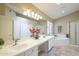 A bathroom featuring double sinks, a large mirror, and a separate bathtub and shower at 908 E Mountain Sage Dr, Phoenix, AZ 85048