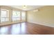 Bedroom with wood floors and view of backyard and pool through multiple windows at 908 E Mountain Sage Dr, Phoenix, AZ 85048