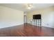 Bedroom featuring wood floors, ceiling fan, and a TV on a storage console at 908 E Mountain Sage Dr, Phoenix, AZ 85048