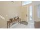 Inviting home entryway featuring tile floors, a console table, and a high ceiling at 908 E Mountain Sage Dr, Phoenix, AZ 85048