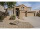 Charming two-story home featuring desert landscaping, a tile roof, and an attached three-car garage at 908 E Mountain Sage Dr, Phoenix, AZ 85048