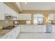 Updated kitchen featuring white cabinets, granite countertops, and modern appliances at 908 E Mountain Sage Dr, Phoenix, AZ 85048