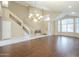 Large living room featuring hardwood floors, a grand staircase, and high ceilings at 908 E Mountain Sage Dr, Phoenix, AZ 85048