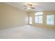 Bright living room with high ceilings, carpet floors, and large windows offering natural light at 908 E Mountain Sage Dr, Phoenix, AZ 85048