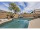 Sparkling pool area with rock waterfall feature, mature landscaping, and scenic mountain backdrop at 908 E Mountain Sage Dr, Phoenix, AZ 85048