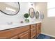 Double sink bathroom with wood cabinets and white countertop at 913 E Tekoa Ave, Gilbert, AZ 85298