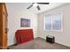 Well-lit bedroom featuring neutral carpeting and a ceiling fan at 913 E Tekoa Ave, Gilbert, AZ 85298