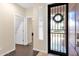 Inviting home entryway with a security door and neutral color palette at 913 E Tekoa Ave, Gilbert, AZ 85298