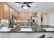 Well-lit kitchen island featuring granite countertops and stainless steel sink at 913 E Tekoa Ave, Gilbert, AZ 85298