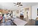 Open-concept living room features dark wood floors, neutral paint, and modern ceiling fan at 913 E Tekoa Ave, Gilbert, AZ 85298