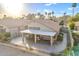 Gorgeous aerial view of the home, featuring a covered patio, desert landscaping, and convenient solar panels at 9409 W Taro Ln, Peoria, AZ 85382