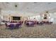 Large ballroom with elegant decor, round tables, purple chairs, and chandeliers at 9409 W Taro Ln, Peoria, AZ 85382