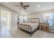 Comfortable bedroom with a modern bed frame, side tables, and an open closet at 9409 W Taro Ln, Peoria, AZ 85382