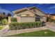 Charming single-story home features a neutral-toned exterior and a two-car garage in Arizona at 9409 W Taro Ln, Peoria, AZ 85382