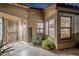 Welcoming front entrance featuring a security door, desert landscaping, and stylish exterior lighting at 9409 W Taro Ln, Peoria, AZ 85382