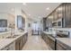 Open concept kitchen featuring gray cabinets, stainless appliances, and a long island at 9409 W Taro Ln, Peoria, AZ 85382