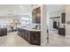 Contemporary kitchen with dark wood cabinets, stainless appliances, and bright countertops at 9409 W Taro Ln, Peoria, AZ 85382