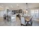 Bright kitchen featuring gray cabinets, a breakfast bar, stainless steel appliances, and a dining area at 9409 W Taro Ln, Peoria, AZ 85382