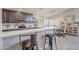 Bright kitchen featuring gray cabinets, stainless appliances, a breakfast bar, and views to the dining area at 9409 W Taro Ln, Peoria, AZ 85382