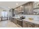 Well-lit kitchen features gray cabinets, stainless appliances, and white quartz counters at 9409 W Taro Ln, Peoria, AZ 85382