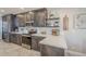 Modern kitchen features gray cabinets, stainless appliances, and white quartz counters at 9409 W Taro Ln, Peoria, AZ 85382