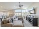 Bright, open-concept living room with vaulted ceiling, tile floors, and comfortable sectional at 9409 W Taro Ln, Peoria, AZ 85382