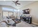 Bright living room featuring a large sectional, entertainment center, and expansive windows at 9409 W Taro Ln, Peoria, AZ 85382