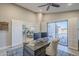 Well-lit home office with a spacious desk, sliding door and outdoor access at 9409 W Taro Ln, Peoria, AZ 85382