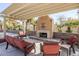 Inviting outdoor space with a large stone fireplace and comfortable seating at 9409 W Taro Ln, Peoria, AZ 85382