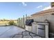 Built-in outdoor kitchen featuring a grill, stainless steel storage, and mini fridge, perfect for entertaining at 9409 W Taro Ln, Peoria, AZ 85382