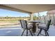 Charming covered patio with a unique barrel table and comfortable seating overlooking a scenic view at 9409 W Taro Ln, Peoria, AZ 85382