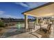 Relaxing covered patio featuring comfortable seating and serene views of the adjacent green space at 9409 W Taro Ln, Peoria, AZ 85382