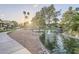 Picturesque pond with a bridge, fountain, and lush landscaping at 9409 W Taro Ln, Peoria, AZ 85382